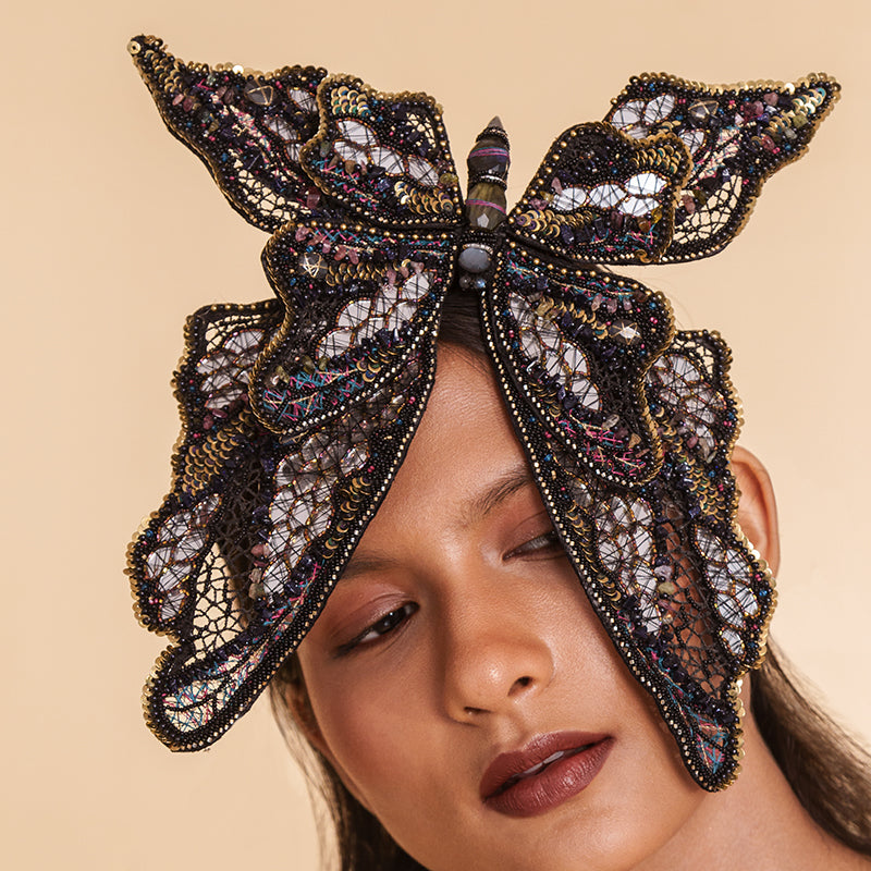 Model wearing Deepa Gurnani handmade the Monarch headband in black color