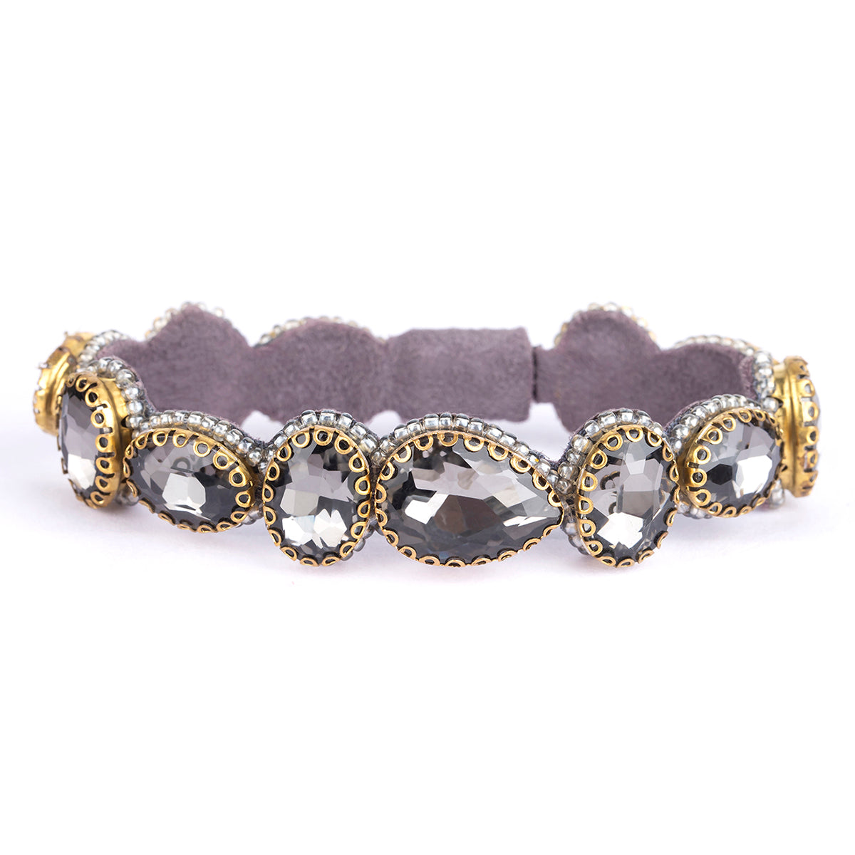 A stretch bracelet featuring five large teardrop-shaped smoky gray gemstones in gold and silver settings, with a soft gray fabric interior, shown on a white background.