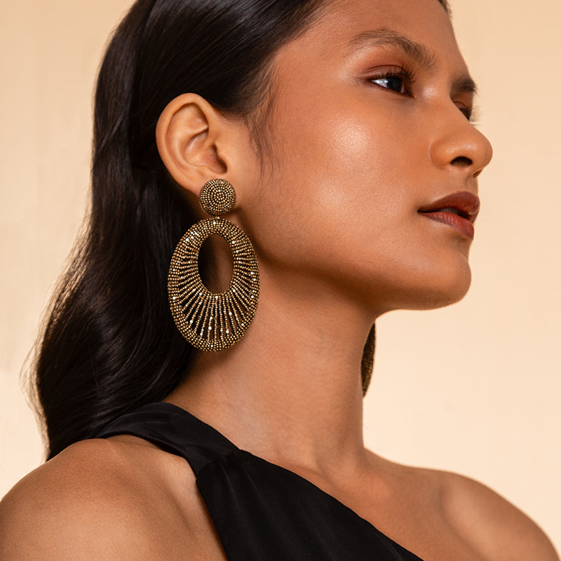 Model wearing Deepa Gurnani Handmade Cypress Earrings in Antique Gold color