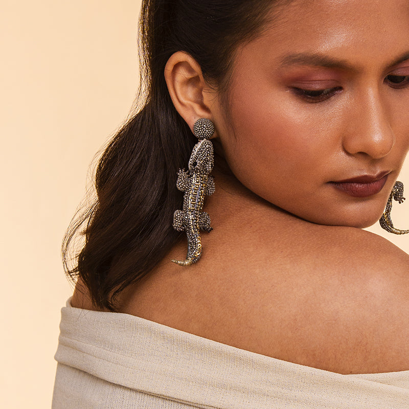 Model wearing Deepa Gurnani handmade the Alligator earrings in olive color