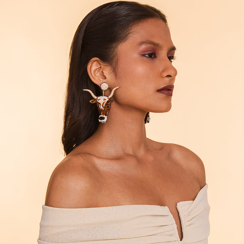 Model wearing Deepa Gurnani handmade the Longhorn earring in Ivory color