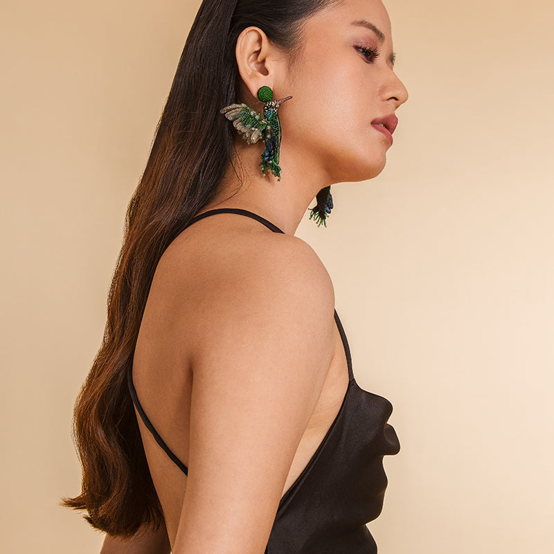 Model wearing Deepa Gurnani Handmade Green Hummingbird Earrings