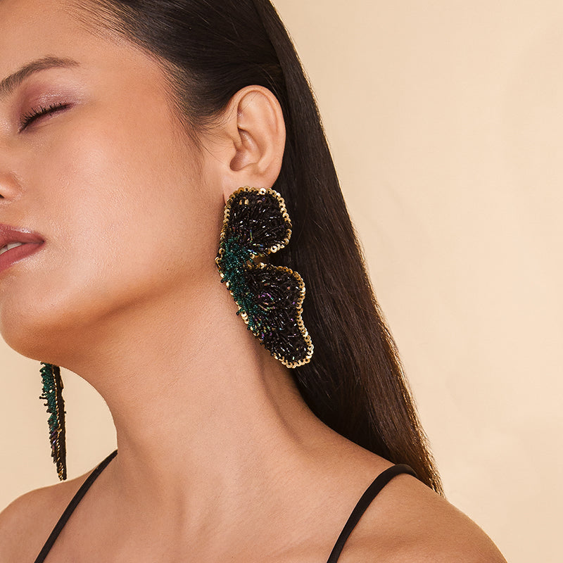 Detail of Model wearing Deepa Gurnani Handmade Lanelle Earrings in Black color