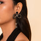 Detail of Model wearing Deepa Gurnani Handmade Coquette Earrings in Black
