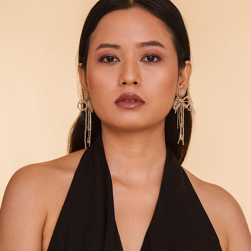 Model wearing Deepa Gurnani Handmade Coquette Earrings in Champagne