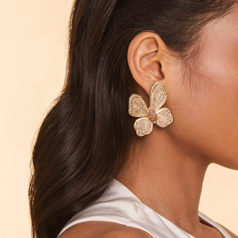 Detail of Model wearing Deepa Gurnani Handmade Abel Earrings in Beige color