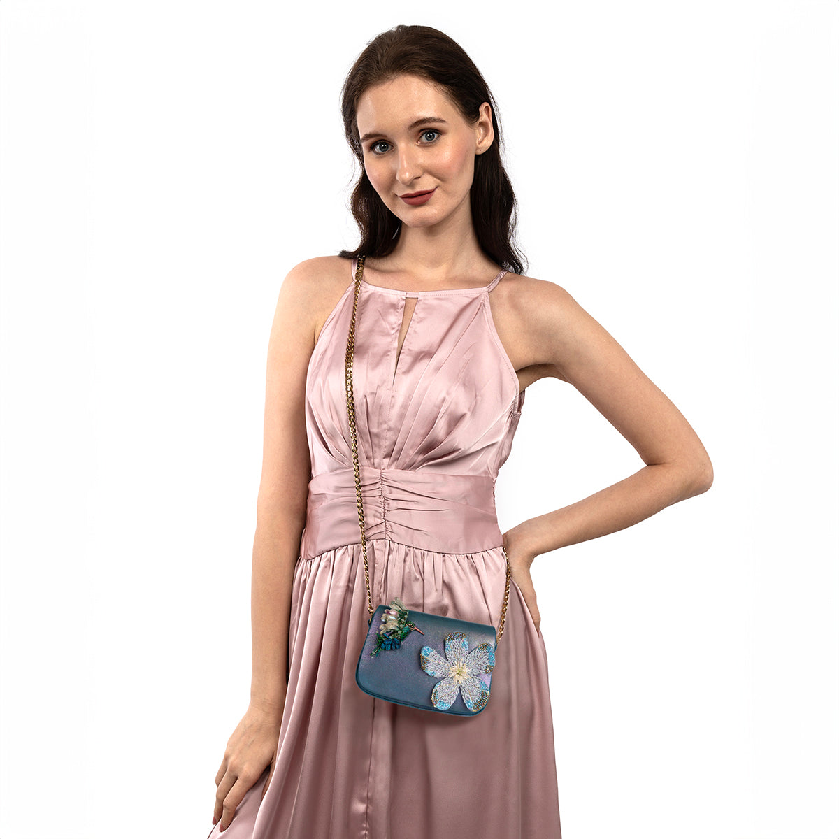 Model carrying Deepa Gurnani Hummingbird clutch in blue color